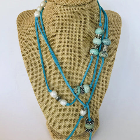 52" necklace. Blue suede, white fresh water pearls, silver accents.